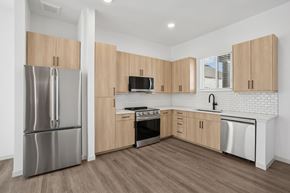 Georgetown townhouse for rent - A kitchen with wooden cabinets and a stainless steel refrigerator.