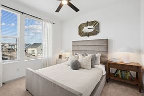 Georgetown townhouse for rent - A bedroom with a large bed and a ceiling fan.