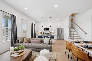 Georgetown townhouse for rent - A modern living room with a grey sofa, a wooden coffee table, and a dining table with chairs.