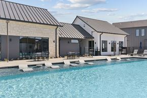 Georgetown townhouse for rent - A swimming pool in front of a house with a black roof.