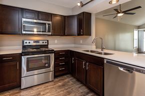 Johnston apartment for rent - diamond kitchen with dark wood cabinets and modern appliances