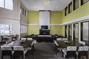Johnston apartment for rent - a clubroom with lots of different seating options, large tv, and chandelier
