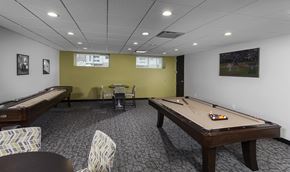 Johnston apartment for rent - a game room with a shuffle board, seating, and games