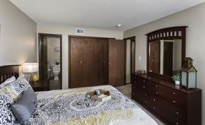 West Des Moines townhouse for rent - bedroom with dresser, large closet, and attached bathroom