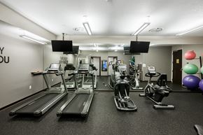 West Des Moines apartment for rent - A gym with treadmills, exercise bikes, and a mirror.