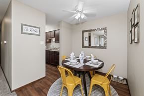 West Des Moines townhouse for rent - A dining room with a round table and yellow chairs.