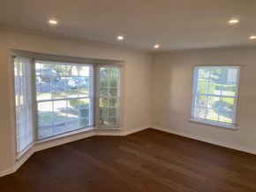 Los Angeles apartment for rent - an empty living room with two windows and a wooden floor