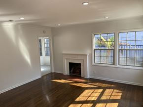 Los Angeles apartment for rent - an empty living room with a fireplace and windows