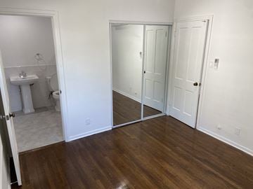 Los Angeles apartment for rent - a bedroom with a mirror and a bathroom with a toilet and a sink