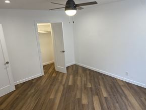 Los Angeles apartment for rent - a bedroom with white walls and wood flooring and a ceiling fan