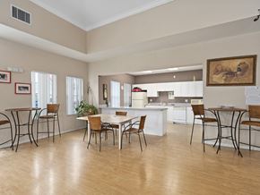 Wimauma apartment for rent - a dining room with a table and chairs and a kitchen at The Groves at Wimauma Apartments , Florida 33598
