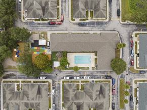 Wimauma apartment for rent - a birds eye view of a neighborhood with houses and a pool at The Groves at Wimauma Apartments , Wimauma, 33598