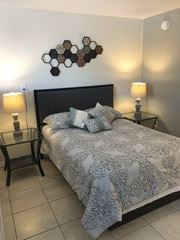 Orlando apartment for rent - a bedroom with a bed and two night stands at Colonial Drive Apartments, Orlando Florida