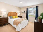 Jacksonville apartment for rent - A bedroom with a bed, nightstand, and window.