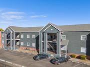 Norman apartment for rent - an apartment building with cars parked in front of it at Emerald Greens, Norman, OK