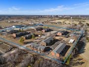Norman apartment for rent - a birdseye view of a neighborhood of houses and a city in the background at Emerald Greens, Norman, 73072