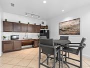 Jacksonville apartment for rent - a kitchen and dining area with a table and chairs at Lake Lofts at Deerwood, Jacksonville, FL, 32216