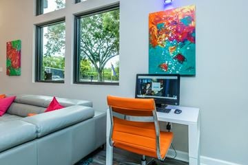 Miami apartment for rent - a living room with a couch and a desk with a computer