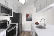 Orlando apartment for rent - a kitchen with black appliances and white cabinets at Lakeside Villas, Florida
