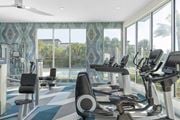 Orlando apartment for rent - a gym with a pool and workout equipment in front of windows at Lakeside Villas, Orlando, 32817