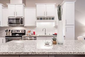 Hopkins apartment for rent - a kitchen with white cabinets and a white counter top
