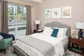 Hopkins apartment for rent - a bedroom with a large window and a large bed