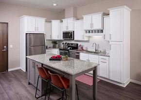 Brooklyn Park apartment for rent - a kitchen with white cabinets and a granite counter top