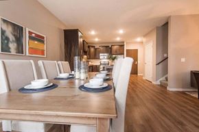 Brooklyn Park apartment for rent - a dining room with a table and chairs and a kitchen in the background