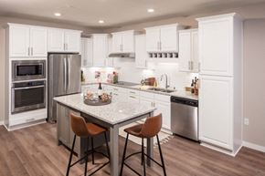 Maple Grove apartment for rent - a kitchen with white cabinets and stainless steel appliances