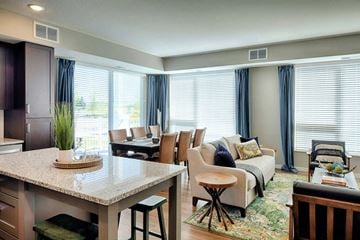 Shakopee apartment for rent - a living room and dining room with a table and chairs