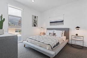 Los Angeles apartment for rent - A bedroom with a large bed and a cactus on the side table.
