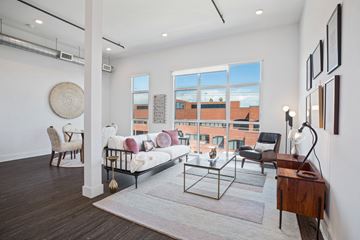 Los Angeles apartment for rent - A living room with a white sofa and a glass coffee table.