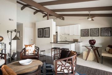 Larkspur apartment for rent - A modern living room with a wooden table and chairs.