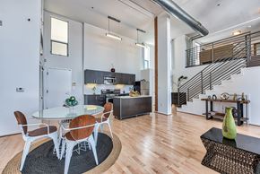 Los Angeles apartment for rent - A modern dining room with a glass table and chairs.