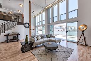 Los Angeles apartment for rent - A living room with a couch, a coffee table, and a staircase.