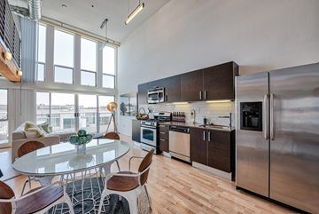 Los Angeles apartment for rent - A modern kitchen with a glass table and stainless steel appliances.