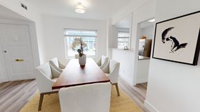 San Francisco townhouse for rent - A dining room with a wooden table and white chairs.