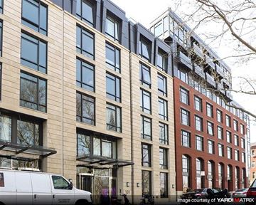 Brooklyn apartment for rent - a large building with a van parked in front of it