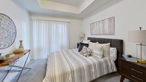 Ogden apartment for rent - a bedroom with a bed and a dresser and a window