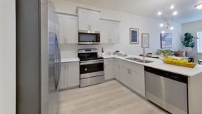 Ogden apartment for rent - a kitchen with stainless steel appliances and white cabinets