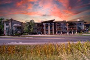 Steamboat Springs apartment for rent - A large apartment complex is shown with a sunset in the background.