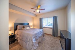 Steamboat Springs apartment for rent - A bedroom with a bed, nightstand, and window.