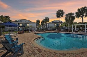 Oakland Park apartment for rent - A swimming pool surrounded by a brick patio and lounge chairs.