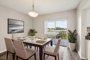 Oakland Park apartment for rent - A dining room with a table set for four and a view of the outdoors through the window.