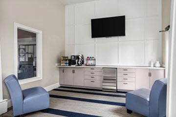 Morrisville apartment for rent - A living room with a blue chair and a white cabinet.