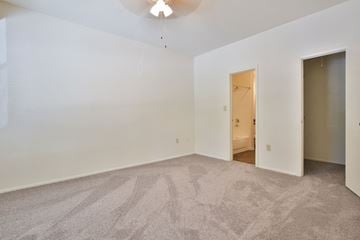 Sarasota apartment for rent - a living room with carpet and a door to a bedroom