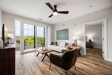 Exton apartment for rent - A living room with a brown chair and a painting on the wall.