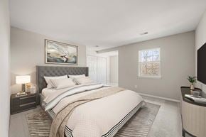 West Chester apartment for rent - A bedroom with a large bed and a painting on the wall.