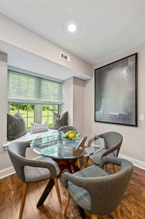 Exton apartment for rent - A modern dining room with a glass table and grey chairs.