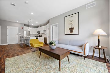 Exton apartment for rent - A living room with a yellow chair and a white couch.